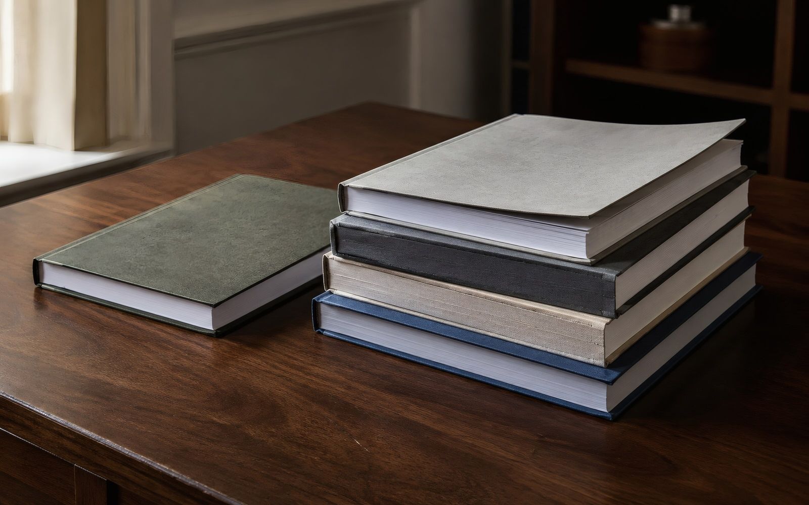 Stack of bound reports on a wooden desk