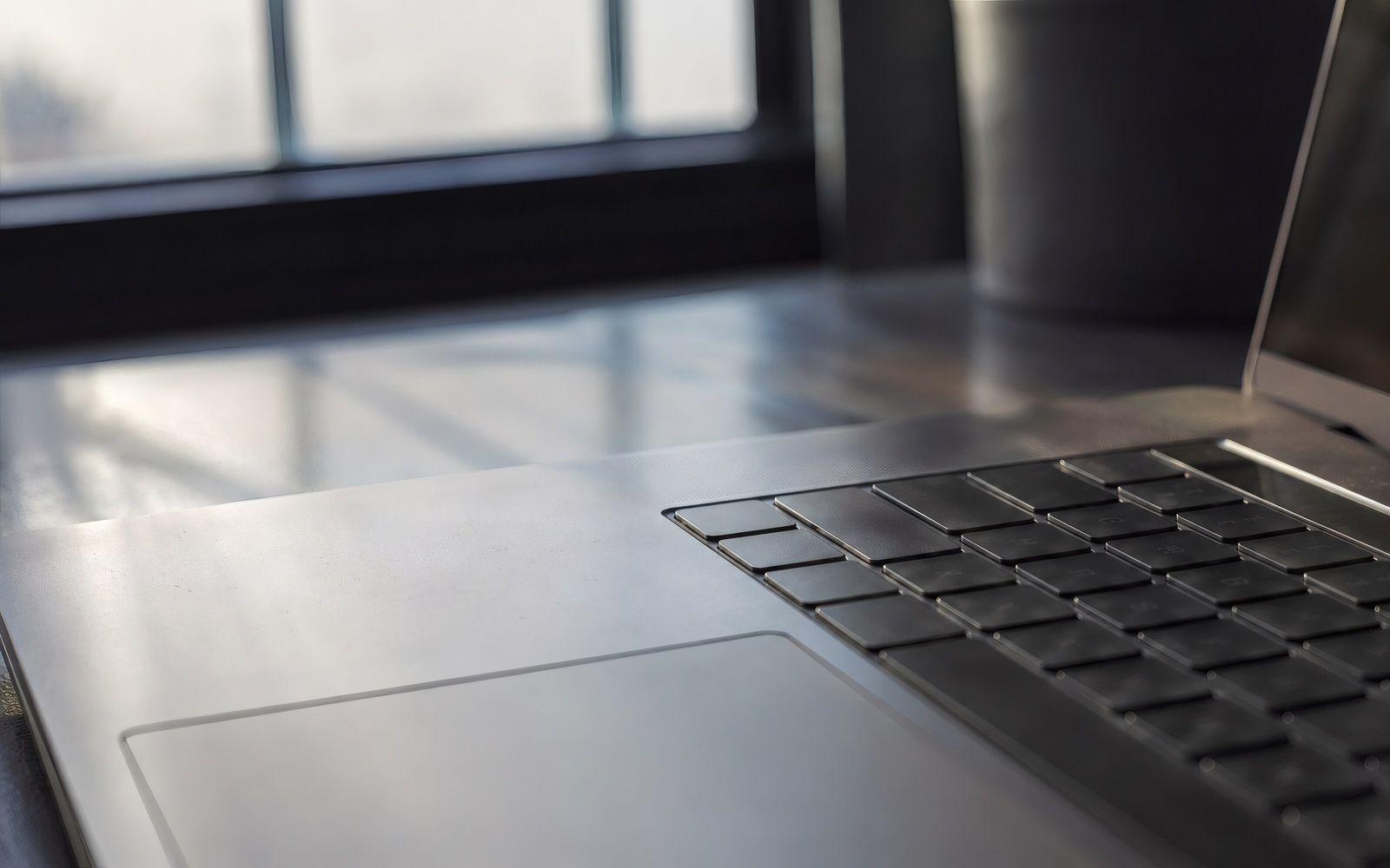 Close view of a laptop keyboard in window light