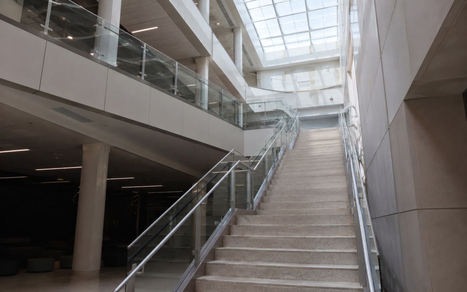 Staircase rising through a daylit atrium